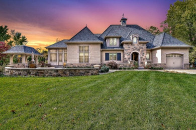 Inspiration for a large craftsman gray two-story stone exterior home remodel in Indianapolis with a shingle roof