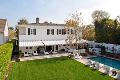 Huge elegant white two-story exterior home photo in Los Angeles