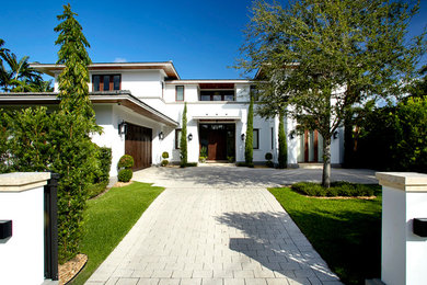 This is an example of a large two-storey white exterior in Miami.