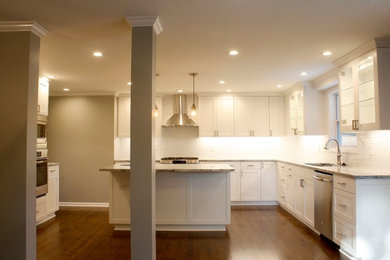 Eat-in kitchen - large modern u-shaped dark wood floor eat-in kitchen idea in Kansas City with an undermount sink, shaker cabinets, white cabinets, granite countertops, white backsplash, ceramic backsplash, stainless steel appliances and an island