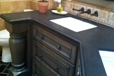 Alcove shower - mid-sized traditional kids' brown tile and mosaic tile slate floor alcove shower idea in Sacramento with an undermount sink, furniture-like cabinets, green cabinets, granite countertops, a one-piece toilet and gray walls