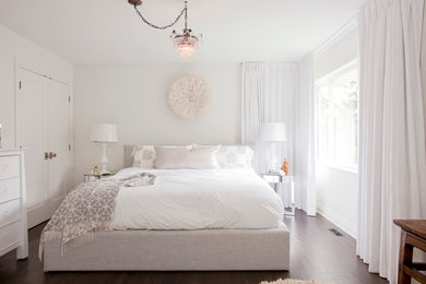 Photo of a transitional bedroom in Vancouver with white walls and dark hardwood floors.