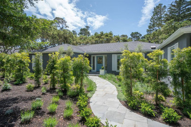 This is an example of a mid-sized coastal partial sun front yard stone landscaping in San Luis Obispo for spring.