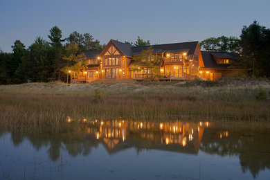 Inspiration for a large rustic brown three-story wood exterior home remodel in Other with a shingle roof