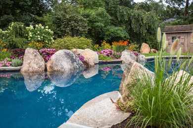 Custom garden pool with boulders and beautiful landscape