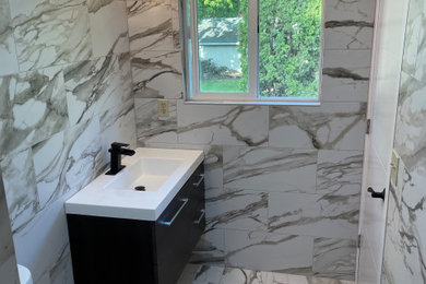 Bathroom - mid-sized contemporary multicolored tile and stone tile ceramic tile, multicolored floor and single-sink bathroom idea in Portland with flat-panel cabinets, dark wood cabinets, a two-piece toilet, multicolored walls, quartz countertops, white countertops and a floating vanity