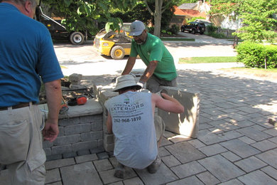 Photo of a mid-sized traditional front yard concrete paver driveway in Milwaukee.
