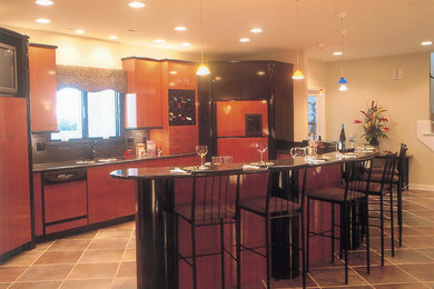 Mid-sized elegant porcelain tile open concept kitchen photo in Indianapolis with an undermount sink, flat-panel cabinets, medium tone wood cabinets, granite countertops, stone tile backsplash, paneled appliances and an island