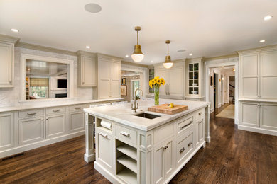 Design ideas for a traditional l-shaped eat-in kitchen in Philadelphia with an undermount sink, marble benchtops, marble splashback, medium hardwood floors, with island and brown floor.