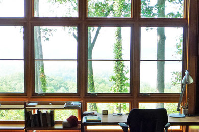 Mid-sized minimalist built-in desk light wood floor study room photo in New York