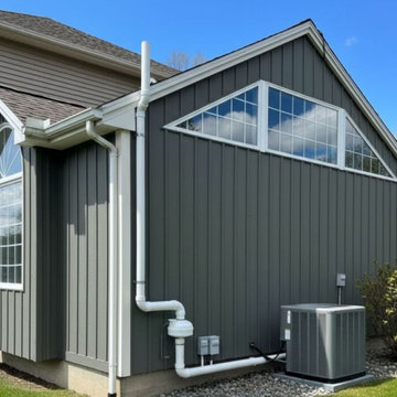 Exterior Radon System on Modern Gray Home Description