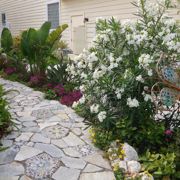 Garden art makes this formerly boring turf space. the plantings give privacy fro