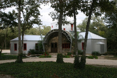 Example of a large farmhouse gray two-story mixed siding exterior home design in Austin with a metal roof