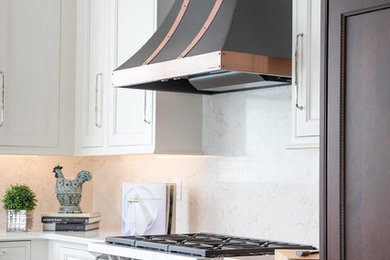 Large elegant l-shaped dark wood floor open concept kitchen photo in Milwaukee with an undermount sink, recessed-panel cabinets, dark wood cabinets, quartz countertops, white backsplash, paneled appliances, an island and white countertops