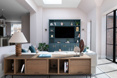 Medium sized eclectic open plan living room feature wall in Cheshire with pink walls, marble flooring and a built-in media unit.