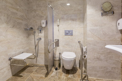 Bathroom - large contemporary master beige tile and stone tile single-sink bathroom idea in Los Angeles with white cabinets, a wall-mount toilet and a floating vanity
