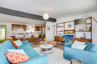 Inspiration for a mid-century modern open concept concrete floor and gray floor living room remodel in Other with white walls and a tv stand