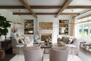 Inspiration for a french country dark wood floor, brown floor and exposed beam living room remodel in Toronto with white walls and a standard fireplace