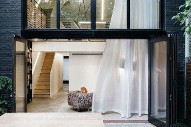 Example of a mid-sized minimalist backyard concrete patio design in New York with no cover