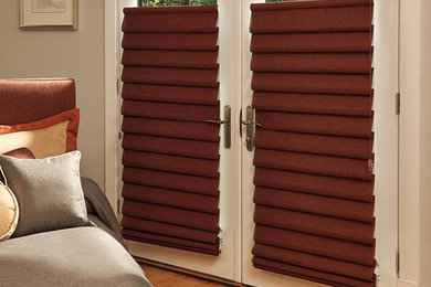Mid-sized minimalist master medium tone wood floor bedroom photo in New York with beige walls