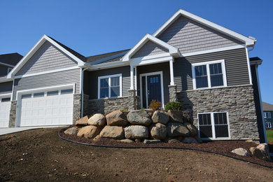 This is an example of a transitional grey exterior in Other with vinyl siding and a gable roof.