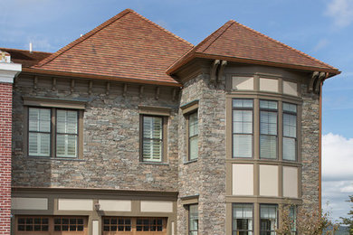Small transitional gray two-story stone exterior home photo in New York