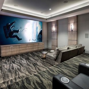 This is an example of an expansive contemporary enclosed home cinema in Houston with a projector screen.