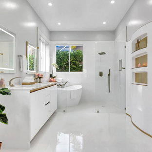 Trendy white tile white floor and double-sink bathroom photo in Miami with flat-panel cabinets, white cabinets, gray walls, an undermount sink, white countertops and a built-in vanity