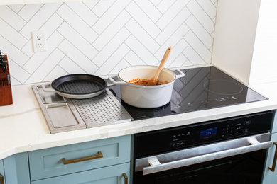 Large minimalist kitchen photo in New York with black appliances