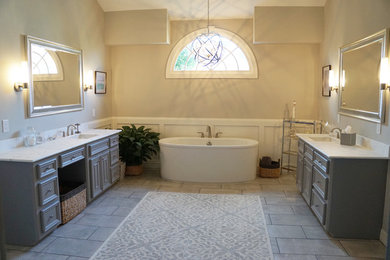 Inspiration for a large transitional master porcelain tile and gray floor bathroom remodel in Houston with raised-panel cabinets, gray cabinets, a two-piece toilet, gray walls, an undermount sink, marble countertops and a hinged shower door