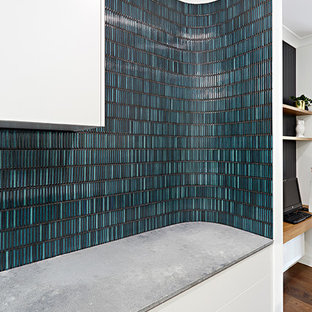 Inspiration for a single-wall kitchen pantry in Melbourne with a drop-in sink, beaded inset cabinets, white cabinets, marble benchtops, subway tile splashback, black appliances, plywood floors and with island.