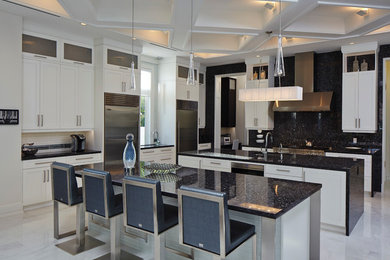 Large trendy l-shaped eat-in kitchen photo in Miami with recessed-panel cabinets, white cabinets, stainless steel appliances and two islands