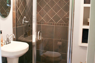 Alcove shower - mid-sized contemporary 3/4 brown tile and ceramic tile ceramic tile alcove shower idea in New York with a pedestal sink, raised-panel cabinets, white cabinets, a one-piece toilet and white walls