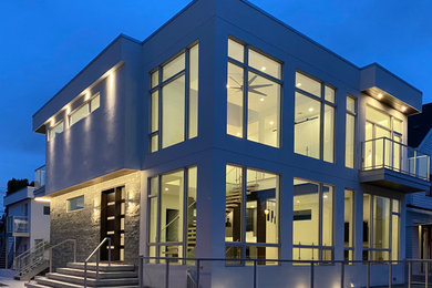 Large contemporary white two-story stucco exterior home idea in Edmonton