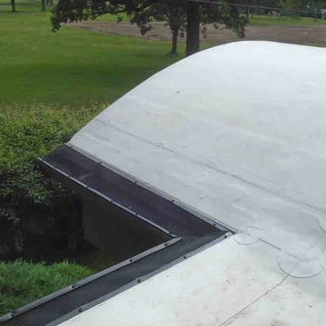 TPO Roofing System over Barrel Roof – Gutters protected with InvisiGuard IG gutt