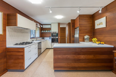 Inspiration for a mid-sized contemporary u-shaped kitchen in Melbourne with quartz benchtops, beige splashback, ceramic splashback, stainless steel appliances, cork floors, beige floor, white benchtop, flat-panel cabinets, white cabinets and a peninsula.