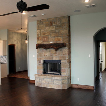 Sandstone see-through fireplace with pecan mantle