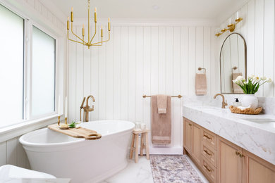 Example of a mid-sized transitional master white tile and porcelain tile porcelain tile, white floor, double-sink and shiplap wall bathroom design in Vancouver with shaker cabinets, light wood cabinets, a two-piece toilet, white walls, an undermount sink, quartz countertops, a hinged shower door, white countertops and a built-in vanity