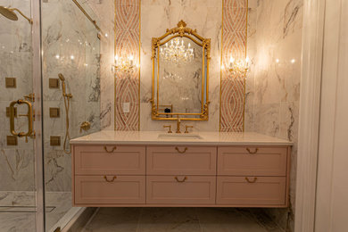Inspiration for a timeless master multicolored tile and porcelain tile porcelain tile, beige floor and single-sink bathroom remodel in Orlando with shaker cabinets, pink cabinets, an undermount tub, a one-piece toilet, multicolored walls, an undermount sink, granite countertops, white countertops and a freestanding vanity