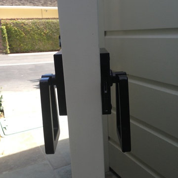 Modern Tapered Ring Gate Latch viewed from the side on the white gate