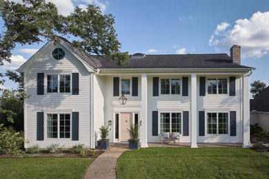 Example of a large classic white two-story concrete fiberboard and clapboard exterior home design in Austin with a shingle roof and a gray roof