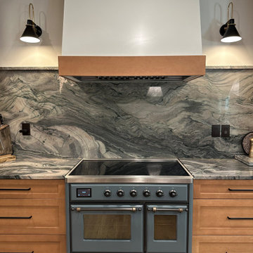 Professional Range with Dramatic Stone Backsplash and Custom Hood