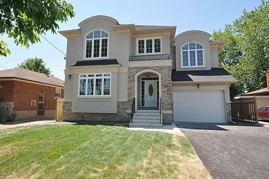 Example of a mid-sized classic beige two-story stucco house exterior design in Toronto with a shingle roof