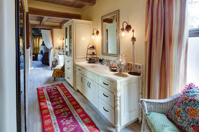 Large southwest master beige tile, blue tile, brown tile and ceramic tile porcelain tile bathroom photo in Albuquerque with recessed-panel cabinets, beige cabinets, yellow walls and an undermount sink