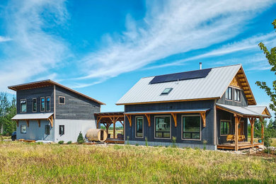 Mid-sized country gray two-story wood exterior home idea in Other with a gray roof and a metal roof