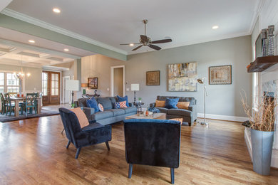 Inspiration for a mid-sized transitional open concept medium tone wood floor and brown floor living room remodel in Other with gray walls, a standard fireplace, a tile fireplace and a tv stand