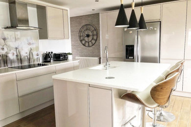 Design ideas for a modern kitchen/diner in Cambridgeshire with composite countertops and white worktops.