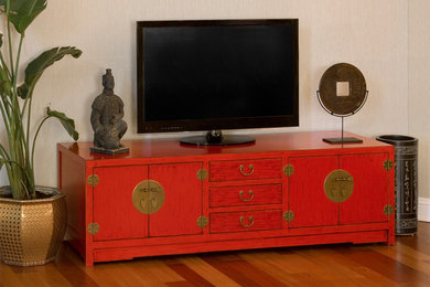Family room - mid-sized asian medium tone wood floor family room idea in Chicago with beige walls, no fireplace and a tv stand