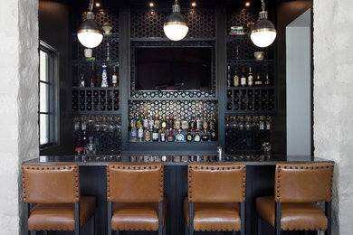 Example of a mid-sized transitional galley brown floor and dark wood floor wet bar design in Austin with an undermount sink, black cabinets, quartzite countertops, black backsplash, glass tile backsplash and brown countertops
