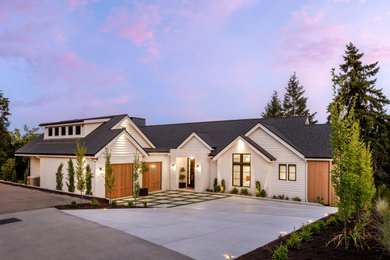 Large traditional yellow two-story mixed siding exterior home idea in Other with a shingle roof and a black roof